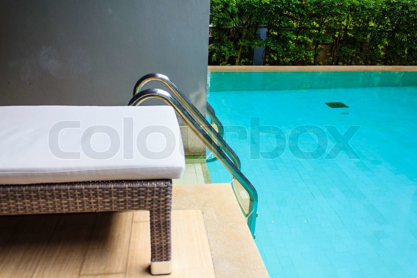 Lounge sunbed in swimming pool | Stock image | Colourbox