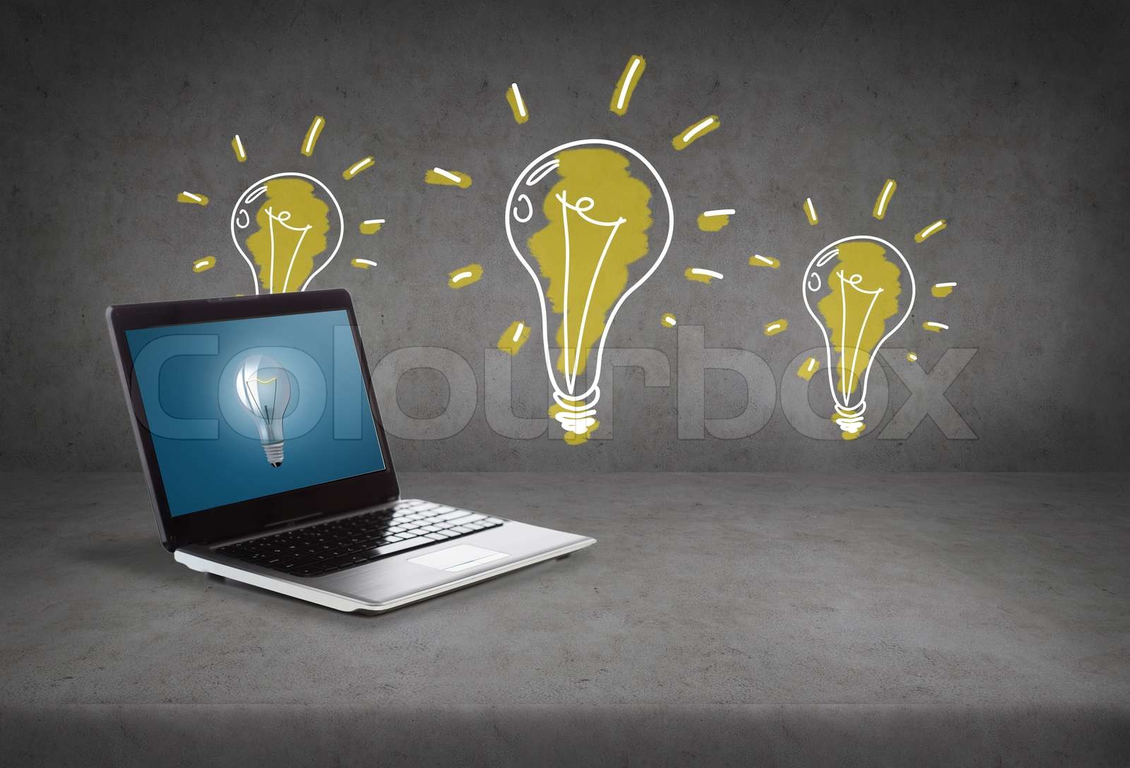 laptop computer with light bulb on screen | Stock image | Colourbox