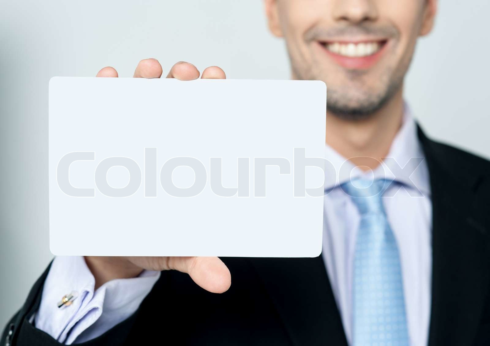 Man hand showing business card | Stock image | Colourbox