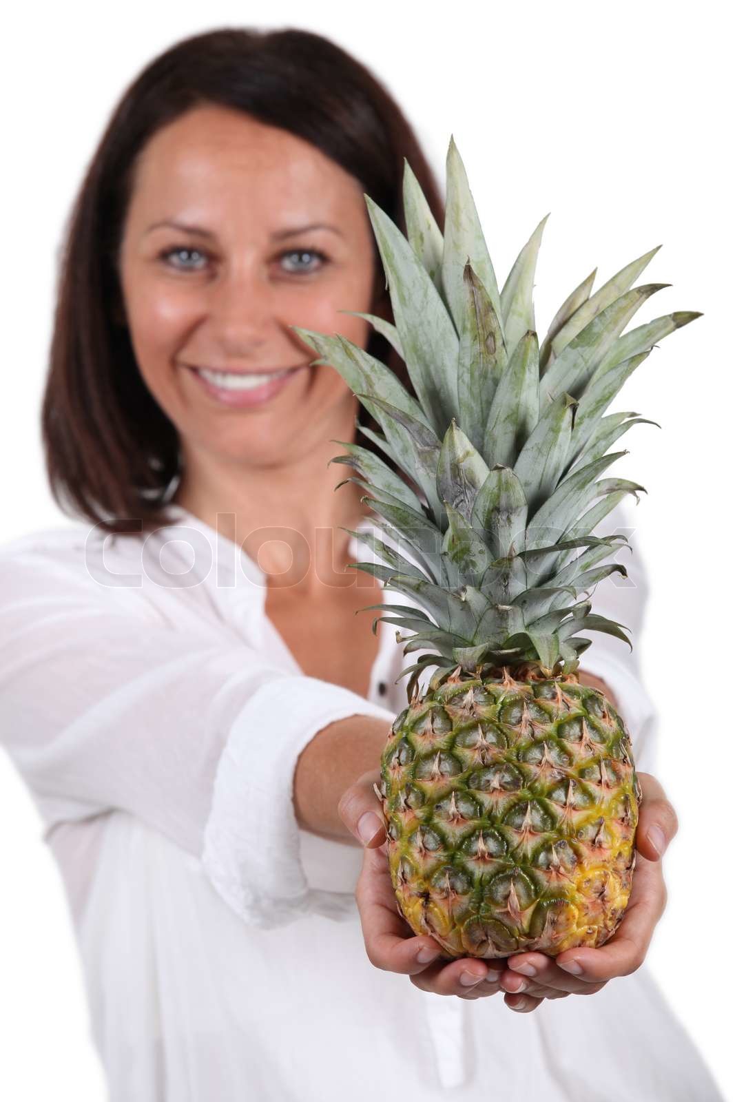 Woman with whole pineapple | Stock image | Colourbox
