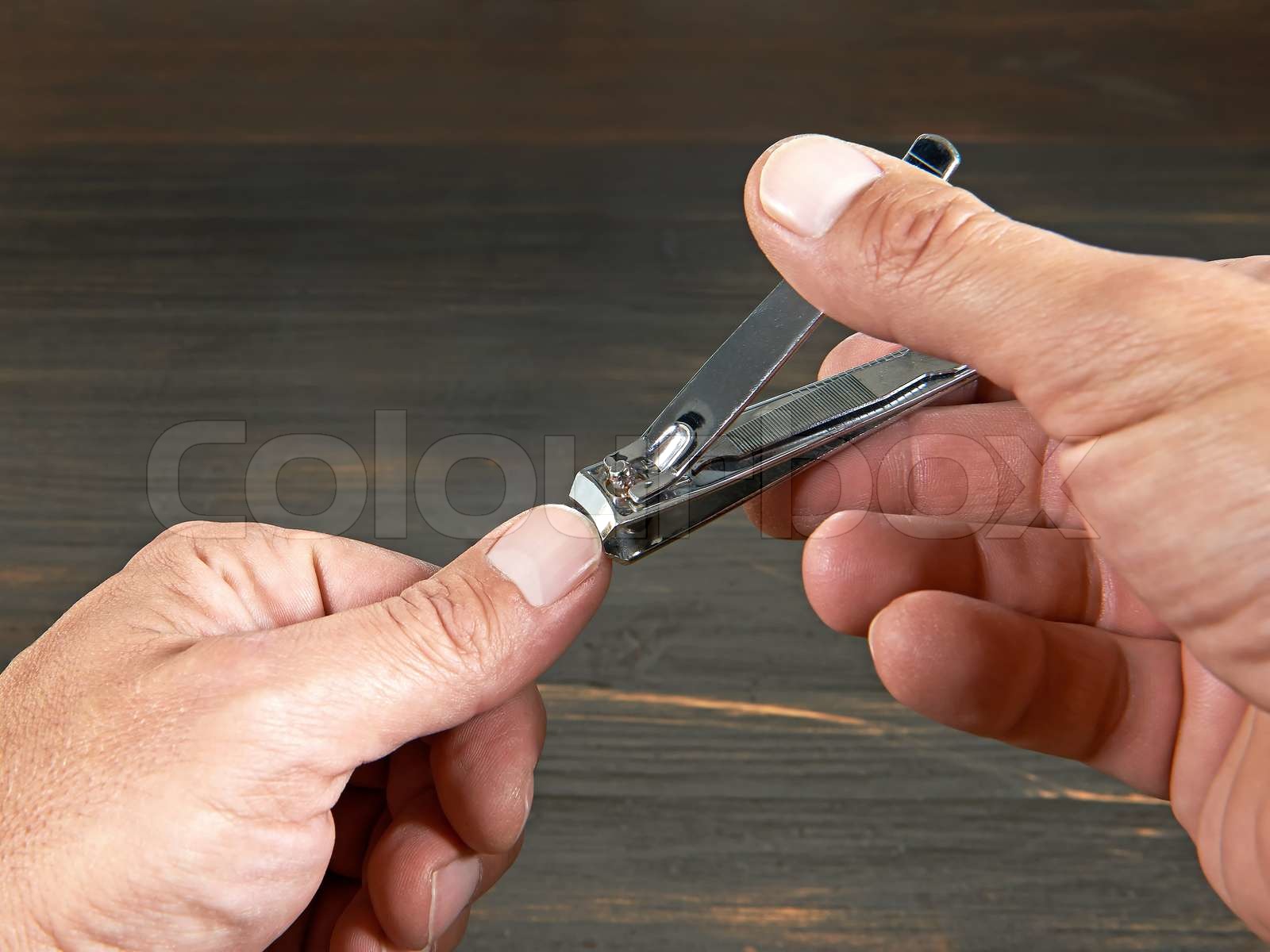 Cutting fingernails Stock foto Colourbox