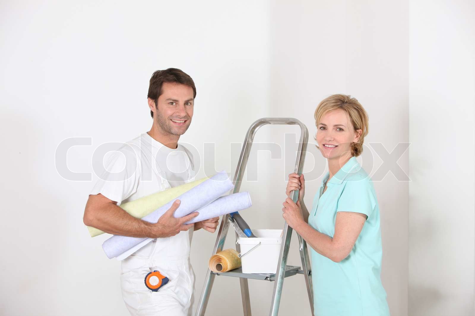 Couple preparing to wallpaper | Stock image | Colourbox
