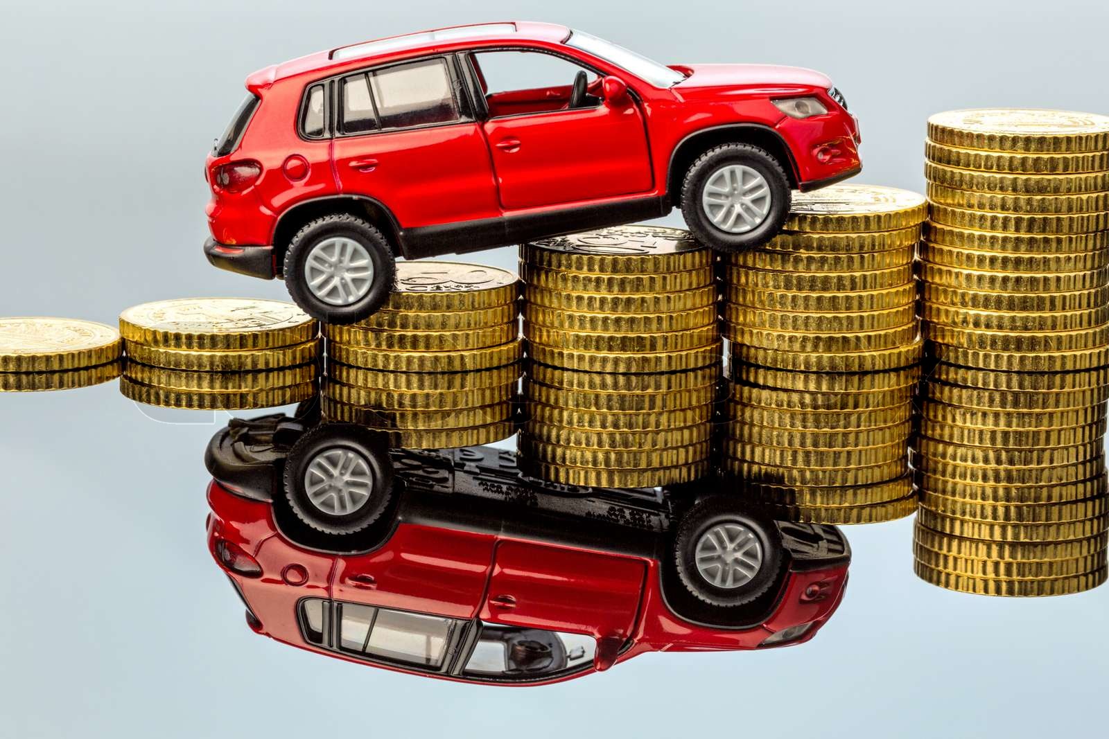 rising motoring costs. car on coins Stock image Colourbox