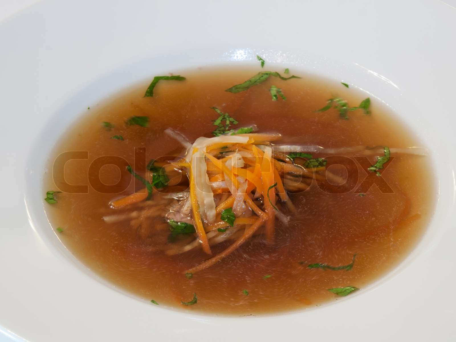 Beef consomme with root vegetables and meat Stock image Colourbox