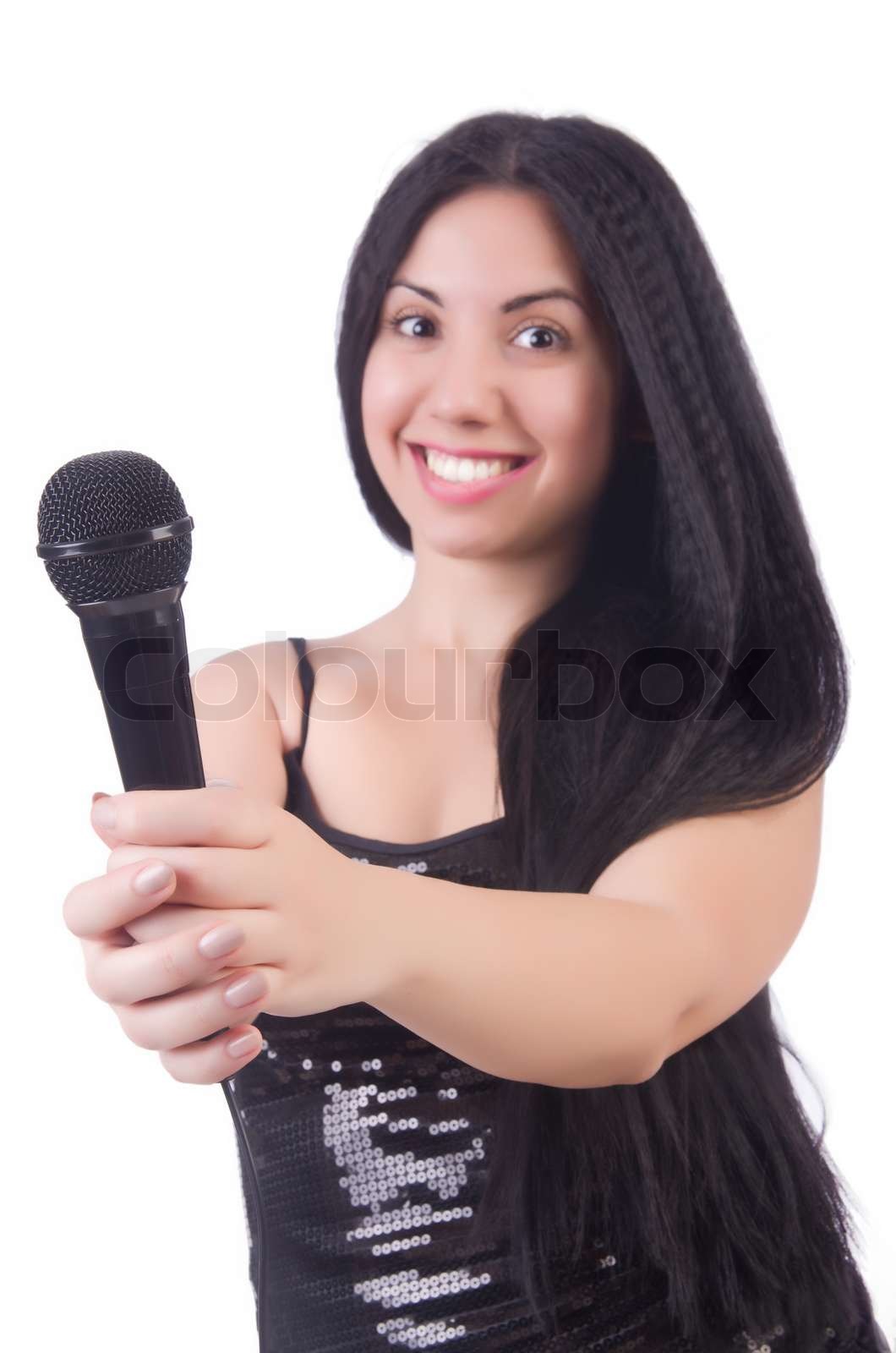 Young female singer with mic on white | Stock image | Colourbox