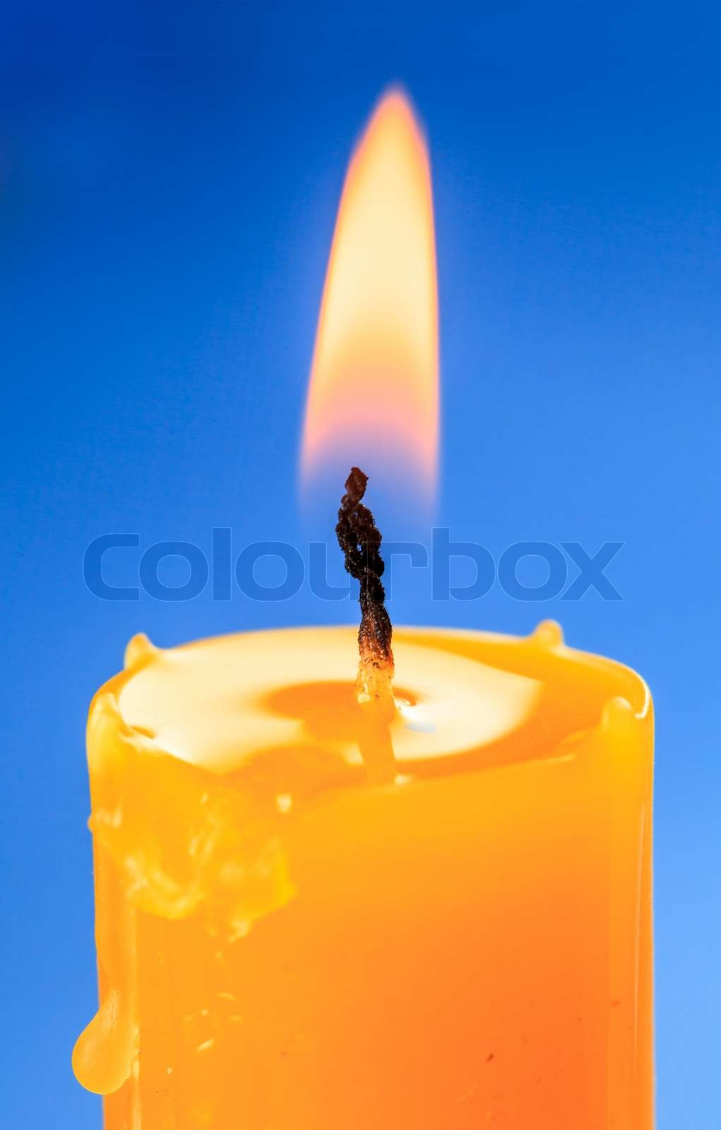 Flame of candle over blue backround | Stock image | Colourbox
