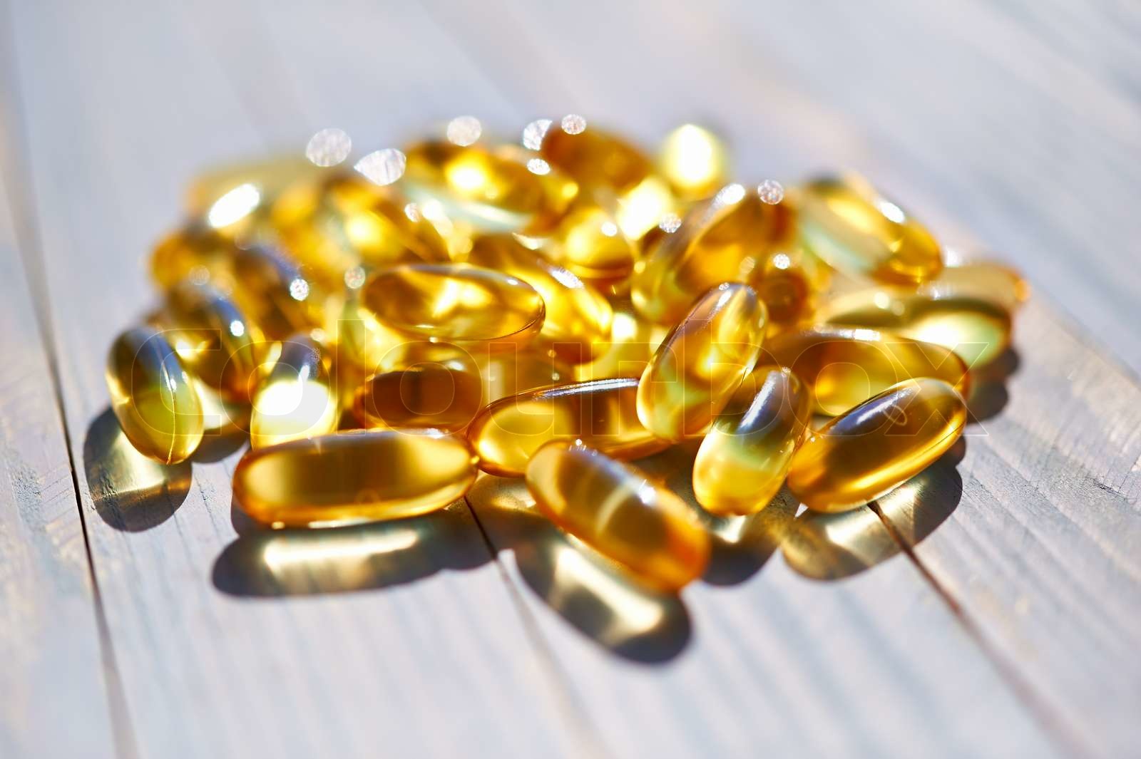 Yellow translucent pills with the fish oil | Stock image | Colourbox