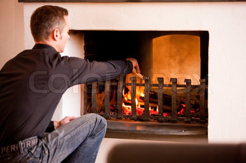 A caucasian man lighting a fireplace | Stock Photo | Colourbox Buy the royalty-free stock image "A caucasian man lighting a fireplace" online ? All image rights included ? High resolution picture for print