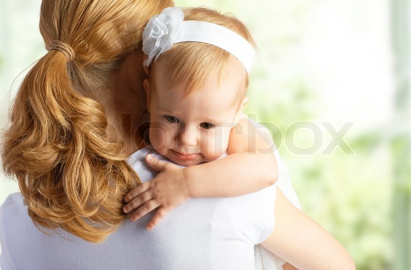 mom hugging baby