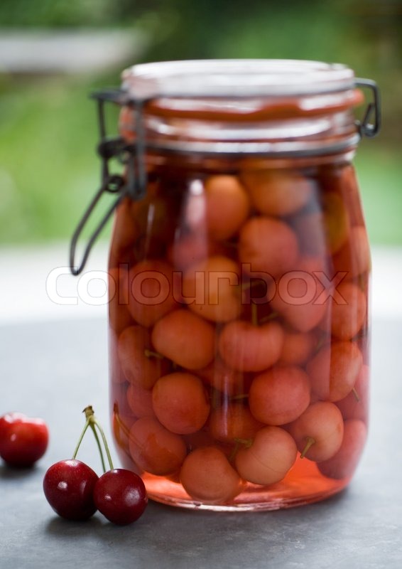 Preserved cherries in a jar Stock Photo Colourbox