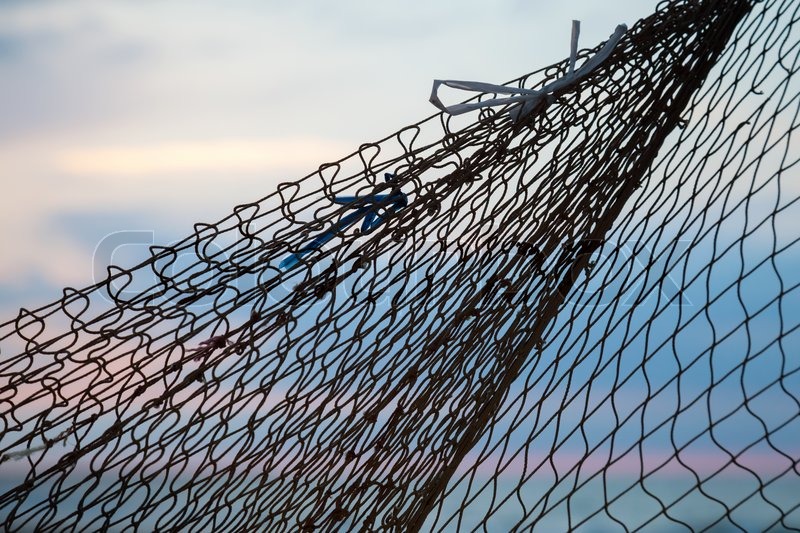 Fishing net silhouette above morning sky background Fishing net silhouette above morning sky background