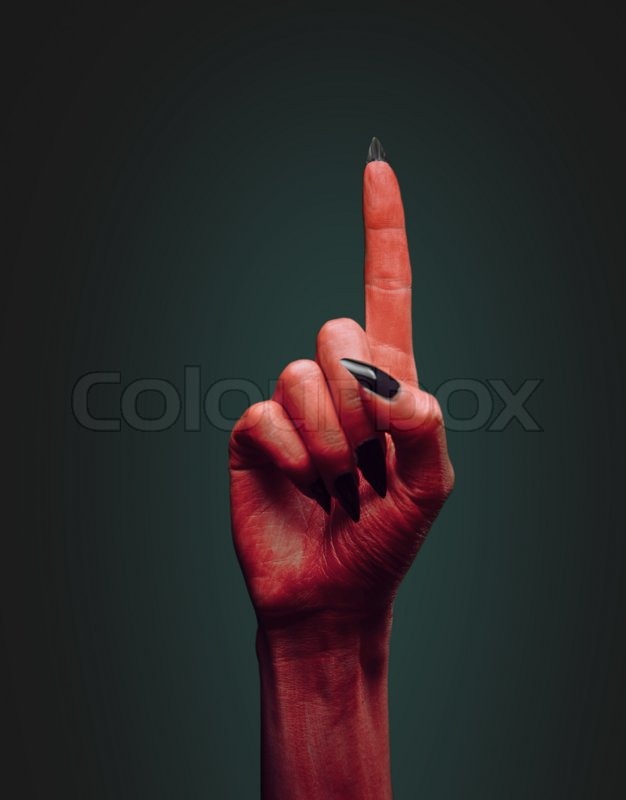 red devil hand with gesture pointing stock photo colourbox
