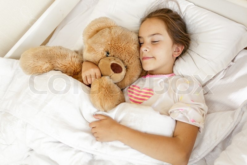 girl hugging a teddy bear