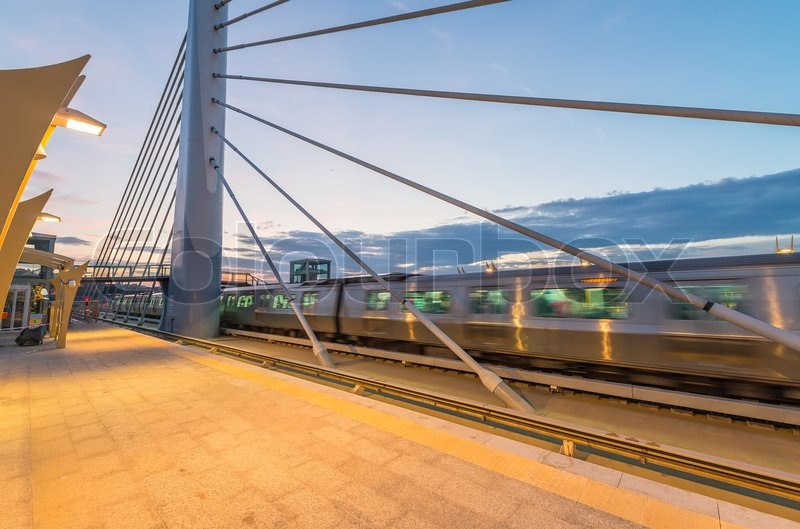 Train speeding up on a station at Stock image Colourbox