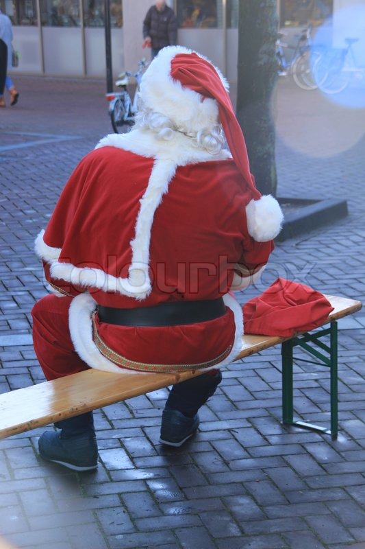 Santa Claus sits on the wooden bench | Stock image | Colourbox