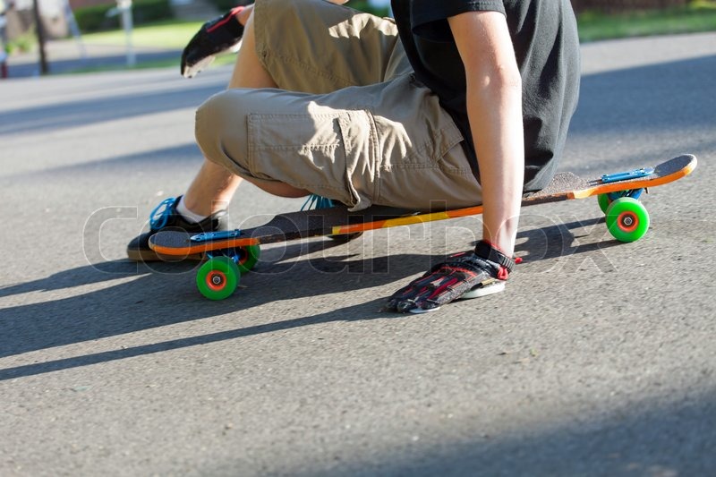 Longboarder resting on his longboard in Stock image Colourbox