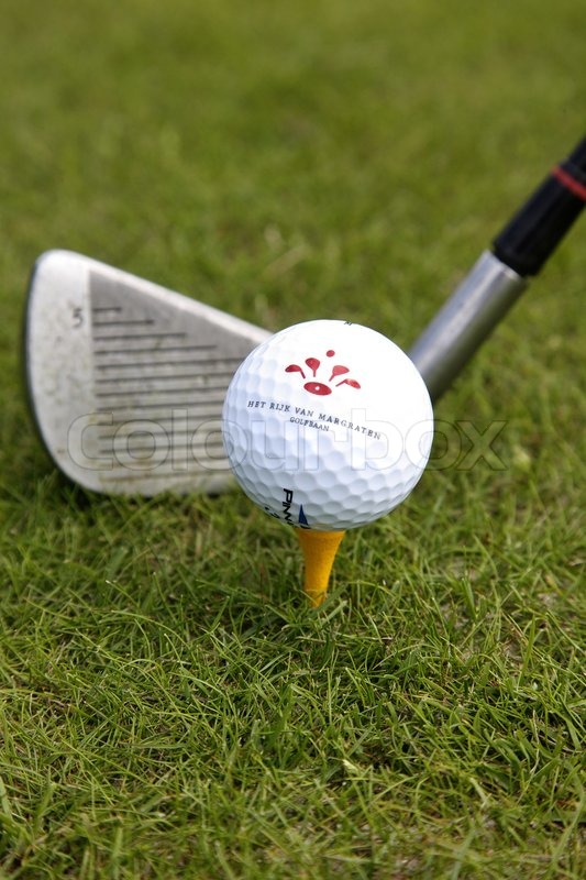 Golf stick and ball on golf course Stock Photo Colourbox