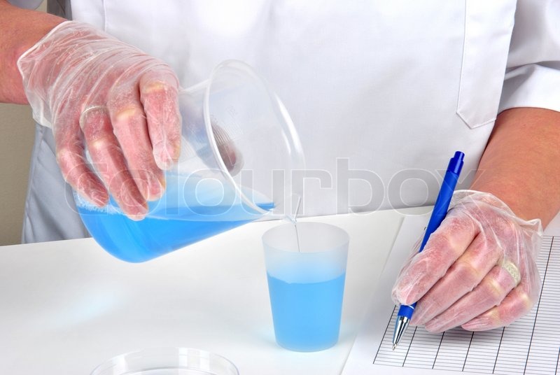 Download Person pouring blue liquid into the measuring cup and ... Yellowimages Mockups