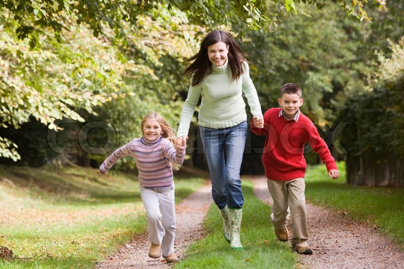 Mother and children running along ... | Stock image | Colourbox