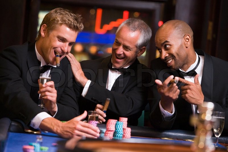 Three men gambling at roulette table in ... | Stock image | Colourbox