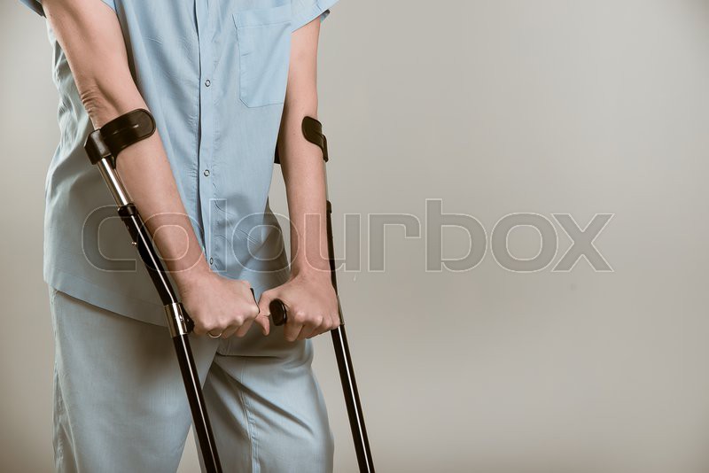 Man with crutches. in the studio Stock image Colourbox