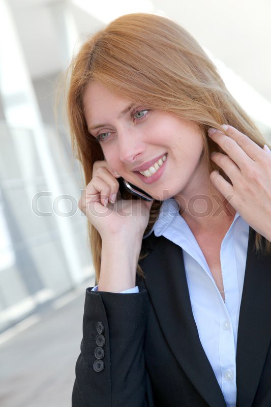 Beautiful saleswoman talking on mobile ...