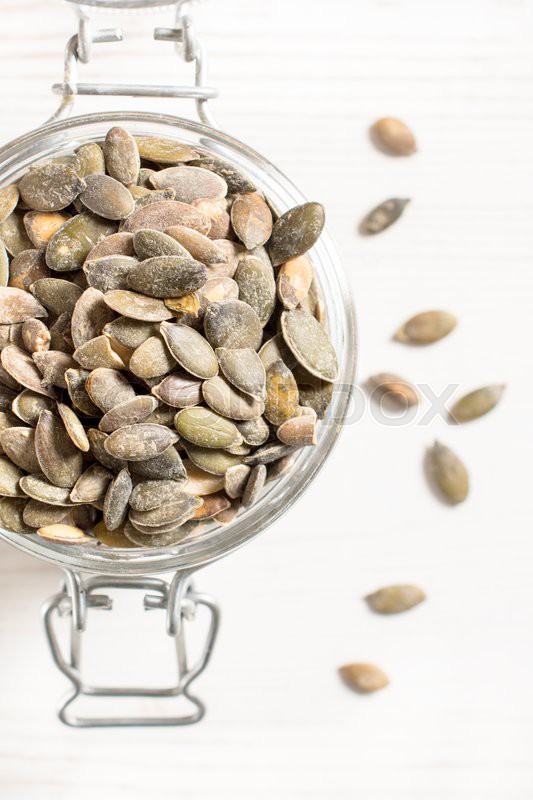 Pumpkin unshelled seeds in the jar from Stock image Colourbox