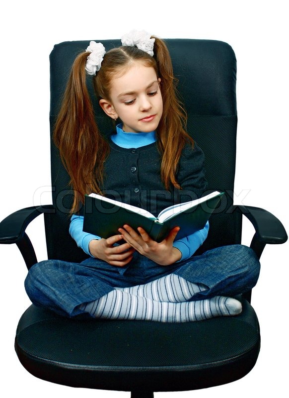 Girl reading a book in chair isolated | Stock image | Colourbox