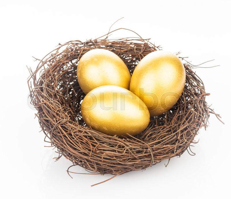 Three golden eggs in the nest isolated Stock Photo Colourbox