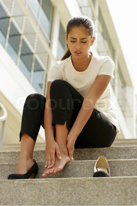 Portrait of latina woman walking on high heels and feeling pain