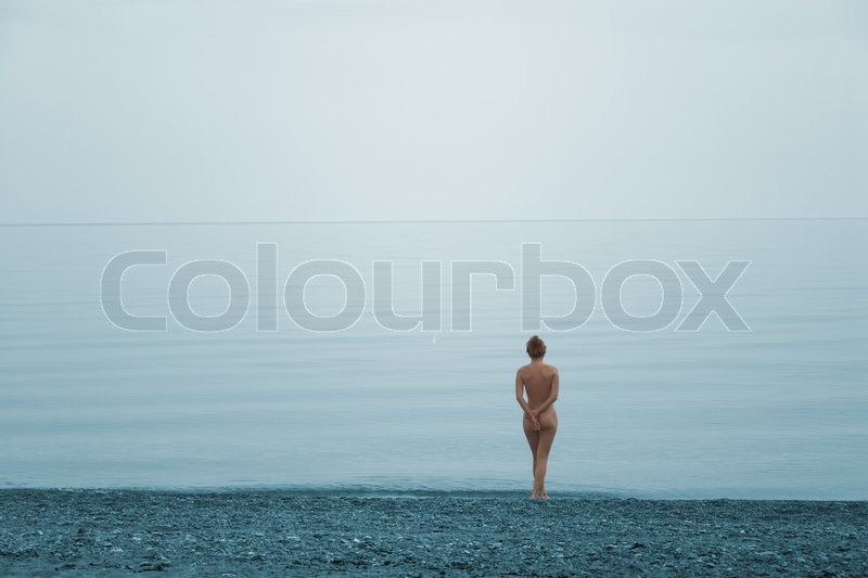 Naked girl running in water