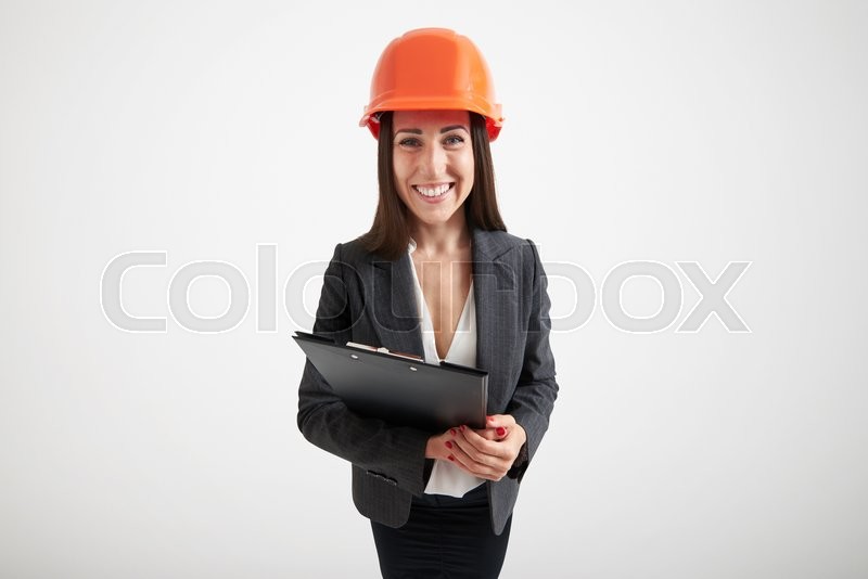wide angle portrait of excited woman in orange hardhat holding black