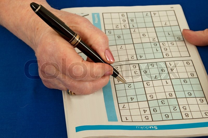 Elderly Woman Doing Sudoku Isolated Stock Photo Colourbox