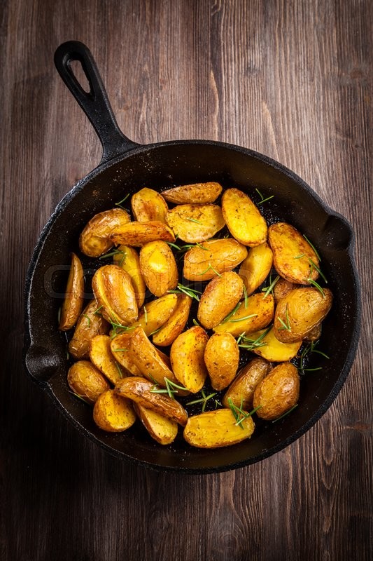 Rustic baked potatoes withherbs in a ... | Stock image | Colourbox