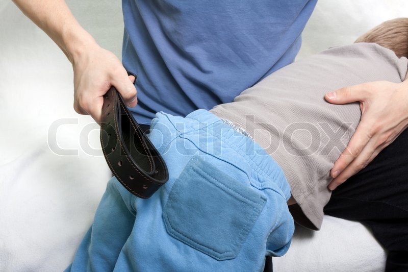 Violence and abuse - little child strap punishment | Stock Photo