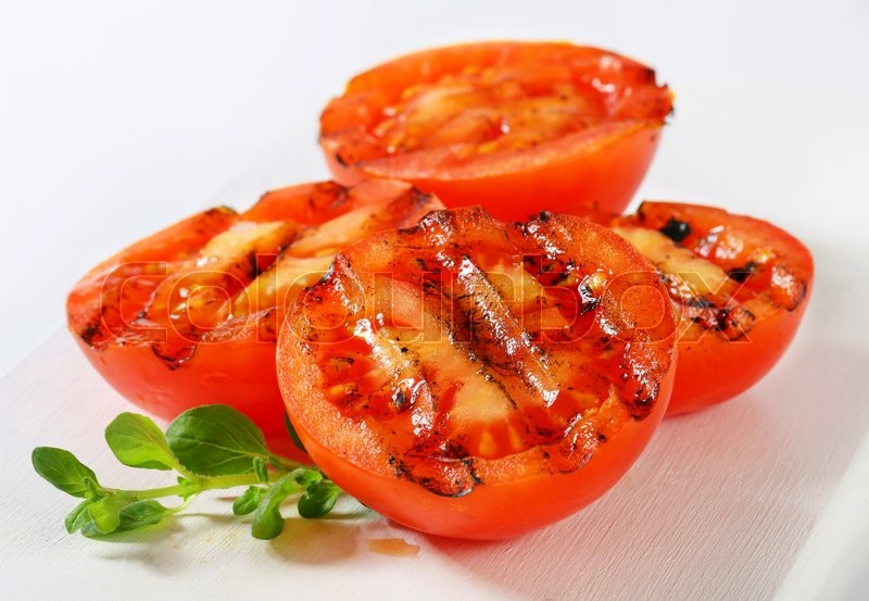 Grilled tomatoes on white cutting board | Stock image | Colourbox