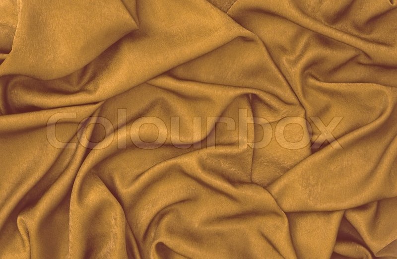 Bronze satin fabric folded to be used Stock Photo Colourbox