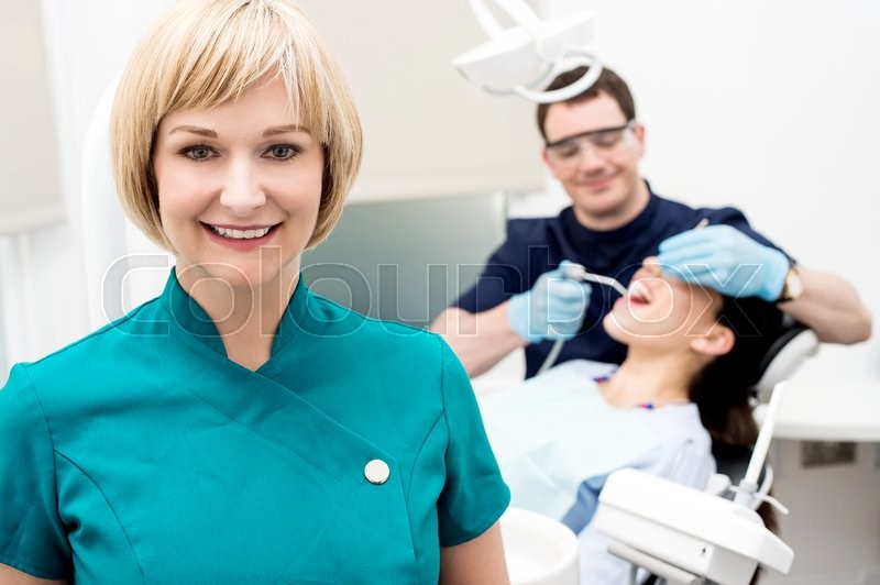 Orthodontist, patient and assistant in Stock Photo