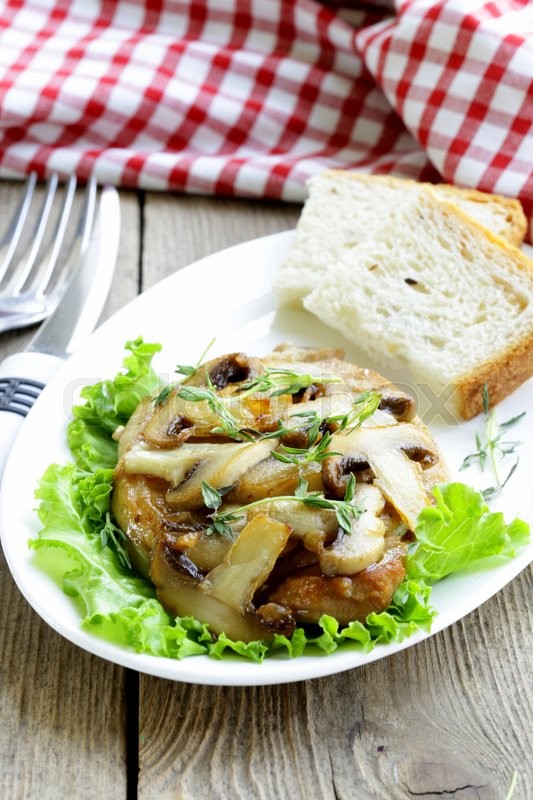 Pork steak with mushroom sauce on a white plate | Stock Photo | Colourbox