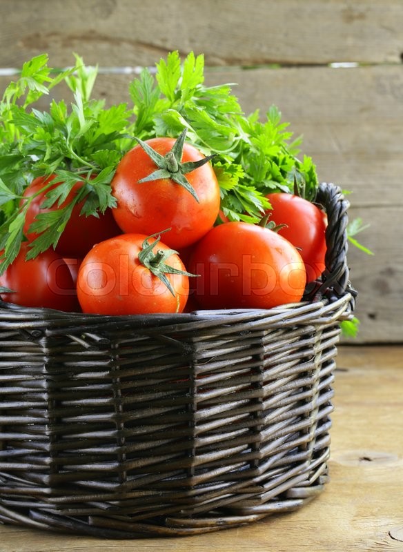 Fresh ripe tomatoes in a basket on the ... | Stock image | Colourbox