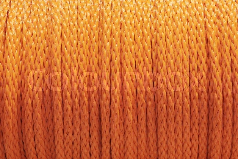 Roll of orange nylon rope in closeup | Stock image | Colourbox