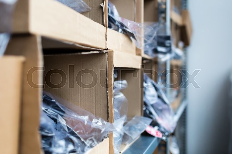 Closeup of cardboard boxes on rack in traditional indoors warehouse