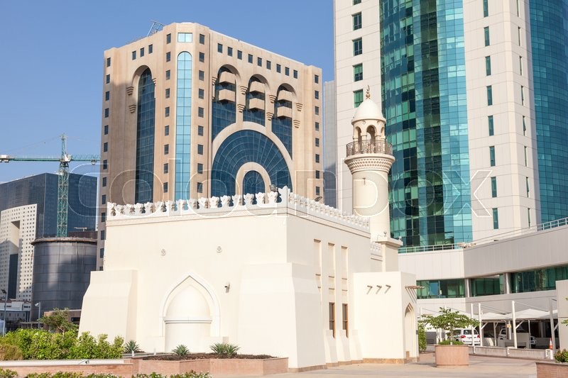 Small local mosque between skyscrapers in Doha downtown. Qatar, Middle East | Stock Photo