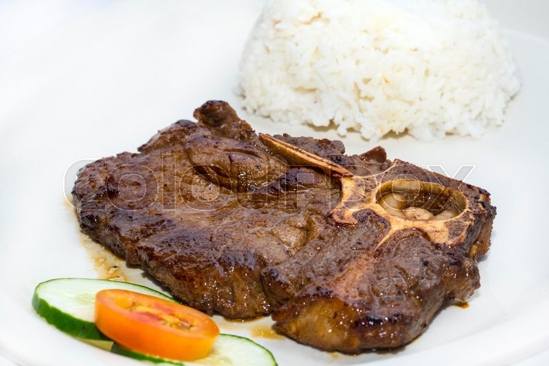 T Bone steak with rice and sauce on a Stock image Colourbox