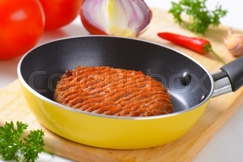 Panfried beef burger patty in pan Stock image Colourbox