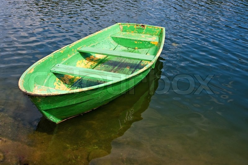 Old green rowing boat on a lake | Stock Photo | Colourbox