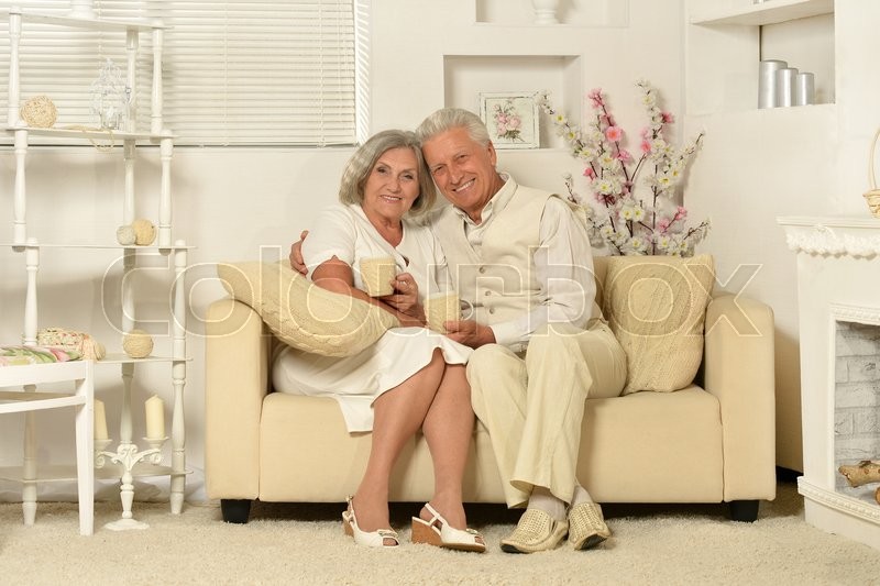 Two Elderly People Sitting On Couch Stock Image Colourbox