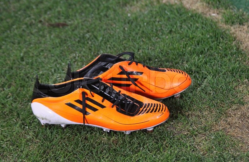Pair of football boots on the grass Stock Photo Colourbox