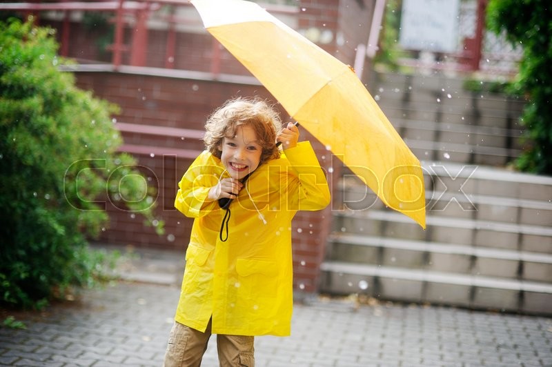 Little fellow in bright yellow raincoat 