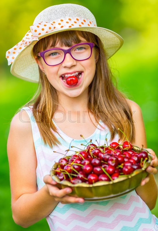 Child with cherries. Little girl with ... | Stock image | Colourbox